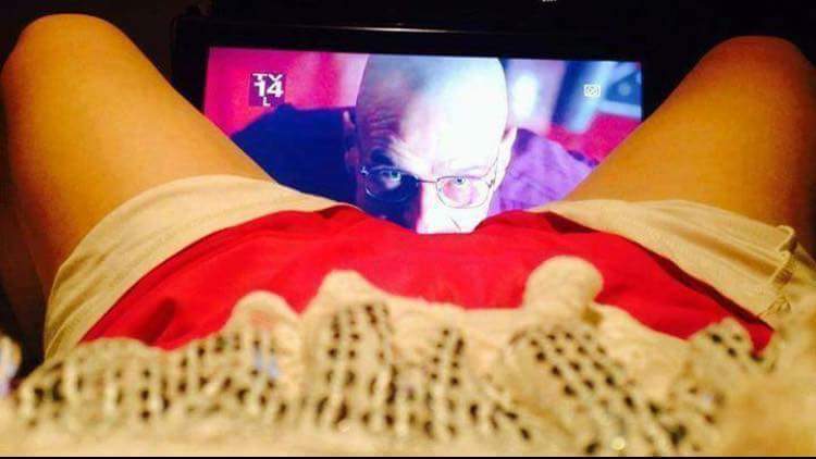 Person watching TV with number 14 displayed